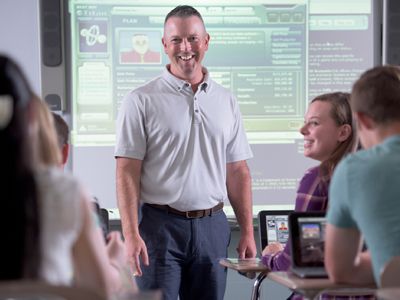 A volunteer working with students